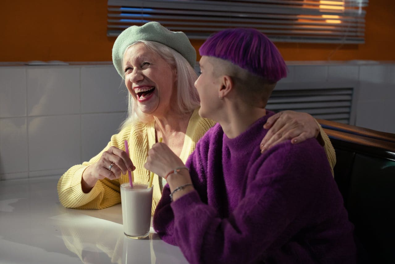 intergenerational women sharing a milkshake